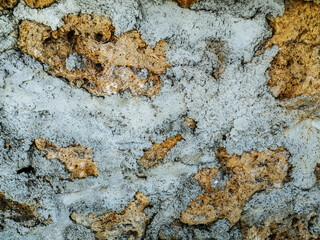 Yellow-gray abstract cement-reinforced sandstone pattern. Colorful grunge texture of old shabby wall