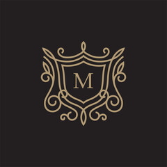 luxury linear shield with floral monogram letter M logotype