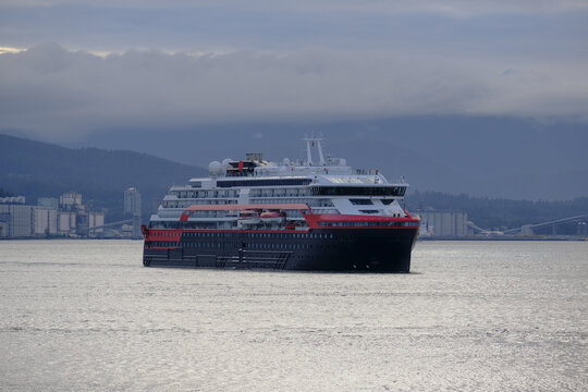 Hurtigruten expedition vessel cruiseship cruise ship liner Roald Amundsen arrival into Port of Vancouver, Canada during early morning sunrise twilight blue hour after Alaska cruising