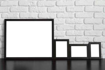 Blank picture frame against brick wall with copy space