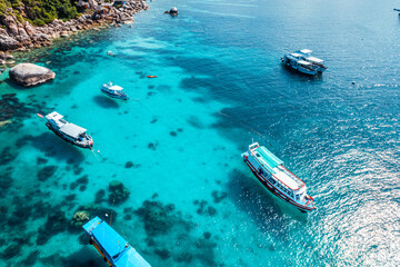 Boats and crystal clear waters at the bay dive site in Koh Tao,diving tour boat