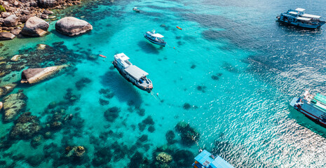 Boats and crystal clear waters at the bay dive site in Koh Tao,diving tour boat