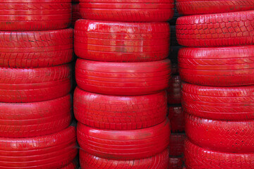Old worn tires are painted red.