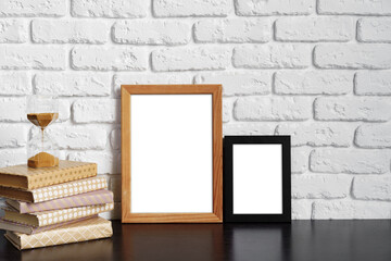 Books with picture frame on wooden table