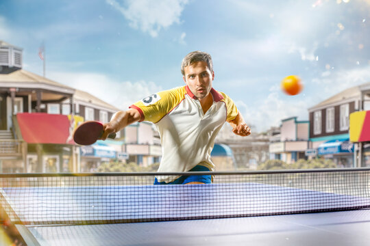 young sports man table tennis player is playing on light background