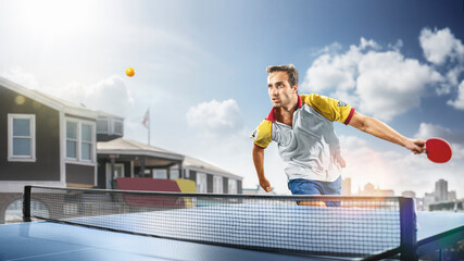 young sports man table tennis player is playing on light background