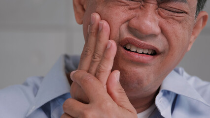 Fototapeta premium Asian senior man suffering from toothache.