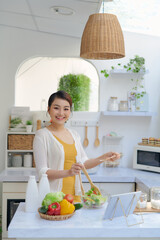 Woman cooking according the tutorial of online virtual master class,