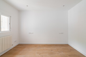 Empty white room with window and natural light. Interior of the freshly renovated room.