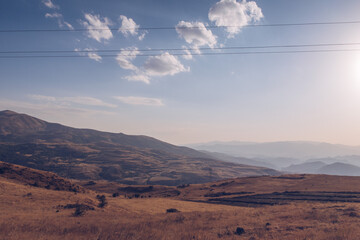 Naklejka premium Armenia mountain autumn view. Dry land mountain range and steppe picturesque landscape view with blue sky. Stock photography.