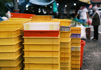 Assorted plastic ocntainers stacked by the roadside of vegetable sellers in Cameron Highlands, Pahang, Malaysia.