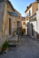 Obraz premium A narrow street between the old houses of Teggiano, a medieval village in the mountains of Salerno province, Italy.