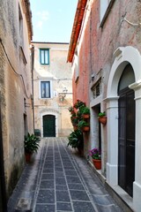 A narrow street between the old houses of Teggiano, a medieval village in the mountains of Salerno...