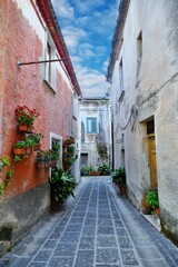 A narrow street between the old houses of Teggiano, a medieval village in the mountains of Salerno...