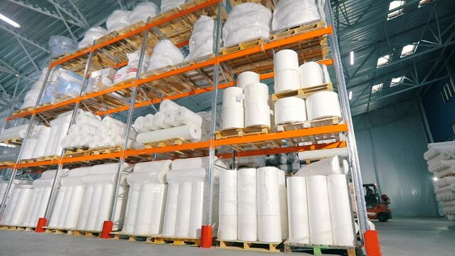 Lots of big rolls of spunbond. Warehouse with rolls of nonwovens. Large warehouse in the nonwovens factory. industrial interior