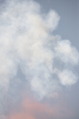Fototapeta na wymiar Red white smoke in the air against the sky.