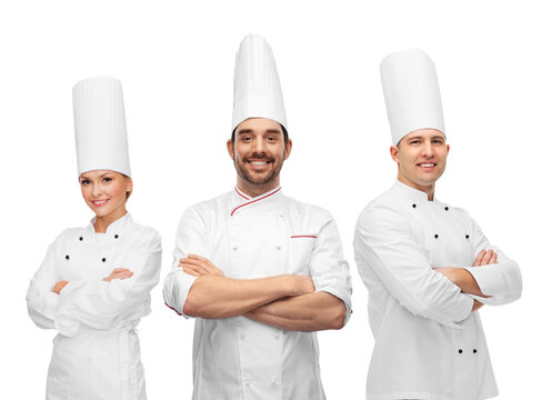 cooking, culinary and profession concept - team of smiling chefs with crossed arms