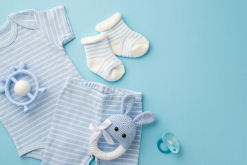 Baby accessories concept. Top view photo of blue infant clothes bodysuit panties socks knitted...