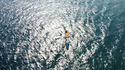 Aerial drone view of windsurfer enjoying on blue sea ocean waves..