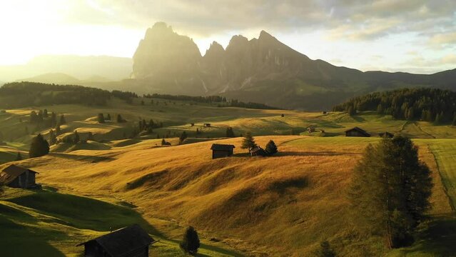 Aerial video of the sunrise in the Dolomites mountains. It was shot on the beautiful meadows of Seiser Alm plateau with fog and mist in the m
orning. 