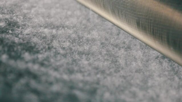 The finished synthetic winterizer leaves the conveyor line close-up. Sintepon close-up. Production of non-woven materials