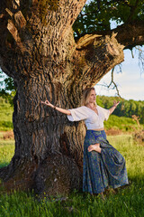 Young woman yoga practitioner in the forest