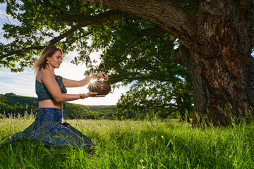 Young woman yoga practitioner in the forest