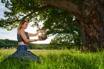 Young woman yoga practitioner in the forest