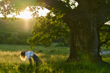 Young woman yoga practitioner in the forest