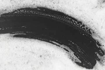Foam bubbles on black background. Washing and cleaning concept.