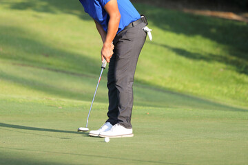 Young male golfer player on golf course