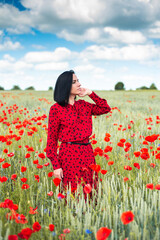 Young brunette beautiful woman enjoying the spring flowers