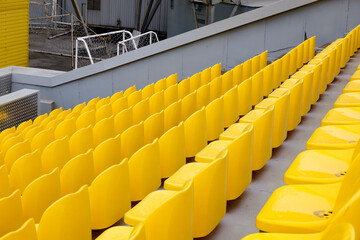 yellow empty seats at a sports stadium