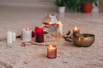 The atmosphere of relaxation meditation lit candles red rose petals essential lie soft fluffy carpet