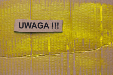 Brown cardboard painted in shades of yellow. On top lies a cut out piece of cardboard with the...