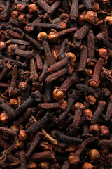 Pile of aromatic cloves as background, top view