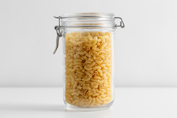 food, eating and cooking concept - jar with pasta on white background - Powered by Adobe