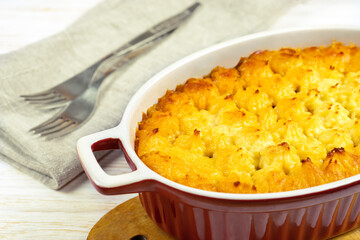 Shepherd's pie or Cottage pie. Minced meat, mashed potatoes and vegetables casserole on white wooden background close up. Traditonal British, United Kingdom, Ireland cuisine