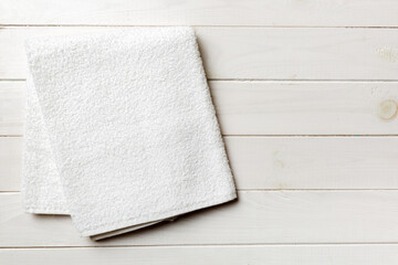 Top view of white towels with copy space on colored background