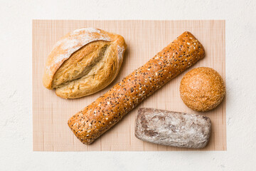 Assortment of freshly baked bread with napkin on rustic table top view. Healthy unleavened bread. French bread
