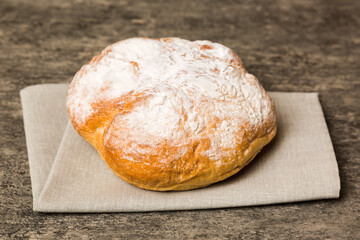 Assortment of freshly baked bread with napkin on rustic table top view. Healthy unleavened bread. French bread