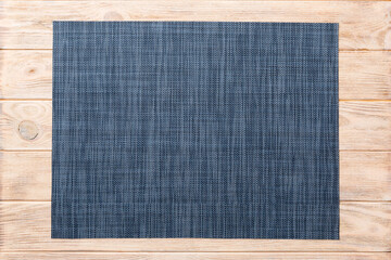 Top view of grey tablecloth for food on wooden background. Empty space for your design