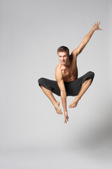 modern ballet male dancer posing over white studio background
