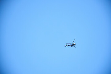Helicopter in flight against the blue sky