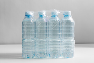 recycling, packing and storage concept - close up of plastic bottles with pure drinking water on...
