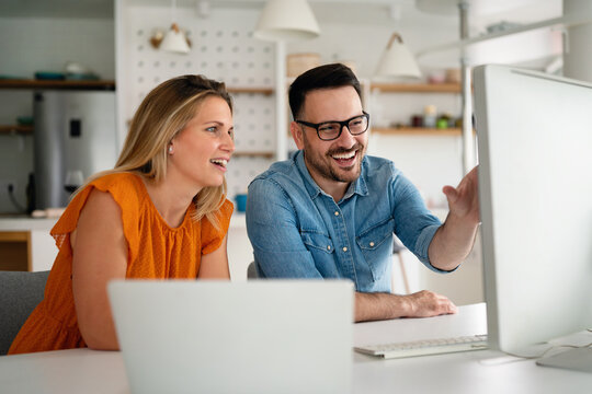 Happy Couple Doing Business Together Working At Small Office