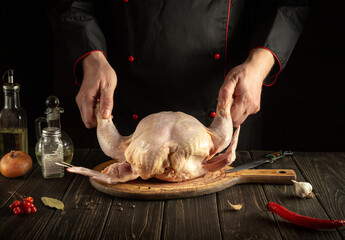 Professional chef prepares raw chicken in the kitchen. Delicious lunch menu idea for a hotel