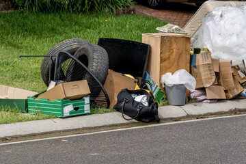 Household miscellaneous rubbish items put on the street for council bulk waste collection - obrazy, fototapety, plakaty