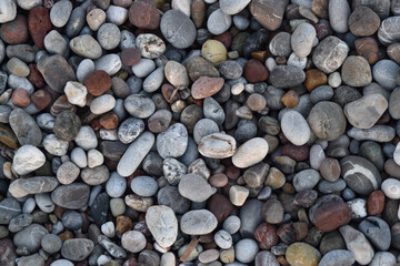 Smooth, colorful pebbles on the seashore.