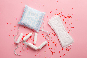 Sanitary pads and tampons on pink background, feminine hygiene products, menstrual cycle, gynecology and menstruation concept